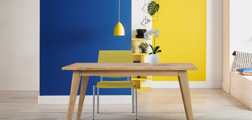 Yellow and blue wall background, interior style, round wood, frame and lamp.